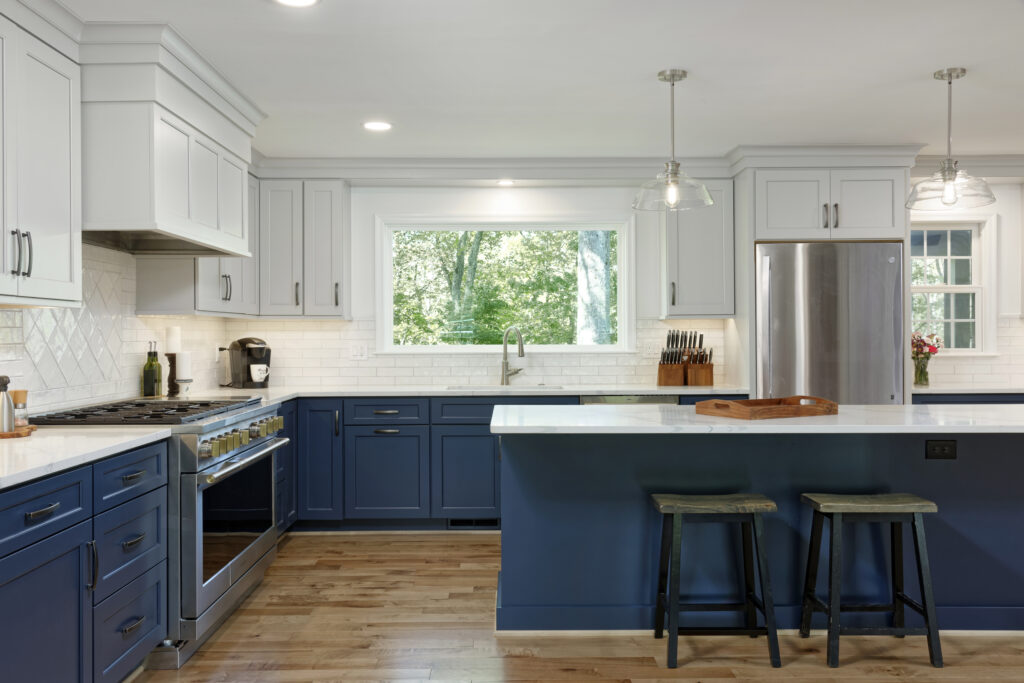 Expanded kitchen with picture window blue and white cabinets