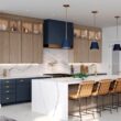 Stunning waterfall island with classic navy blue hood and matching pendants with swan oak contemporary cabinetry.