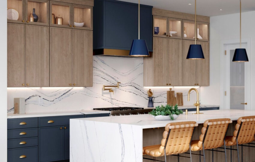 Stunning waterfall island with classic navy blue hood and matching pendants with swan oak contemporary cabinetry.